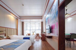 A hotel room with two beds, a desk with a television, a pool table, and a large window. - Furong Lijing Hotel (Yongshun)