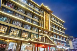 A multi-story hotel with illuminated signage and a traditional architectural design. - Furong Lijing Hotel (Yongshun)