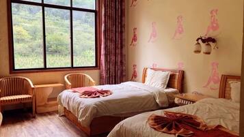 Une chambre avec deux lits, une fenêtre donnant sur un beau paysage, une chaise et un mur agrémenté d’éléments décoratifs.