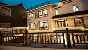 A multi-story building with balconies and large windows, likely a hotel or residential complex. - Sushangyuan Boutique Hostel (Suzhou)
