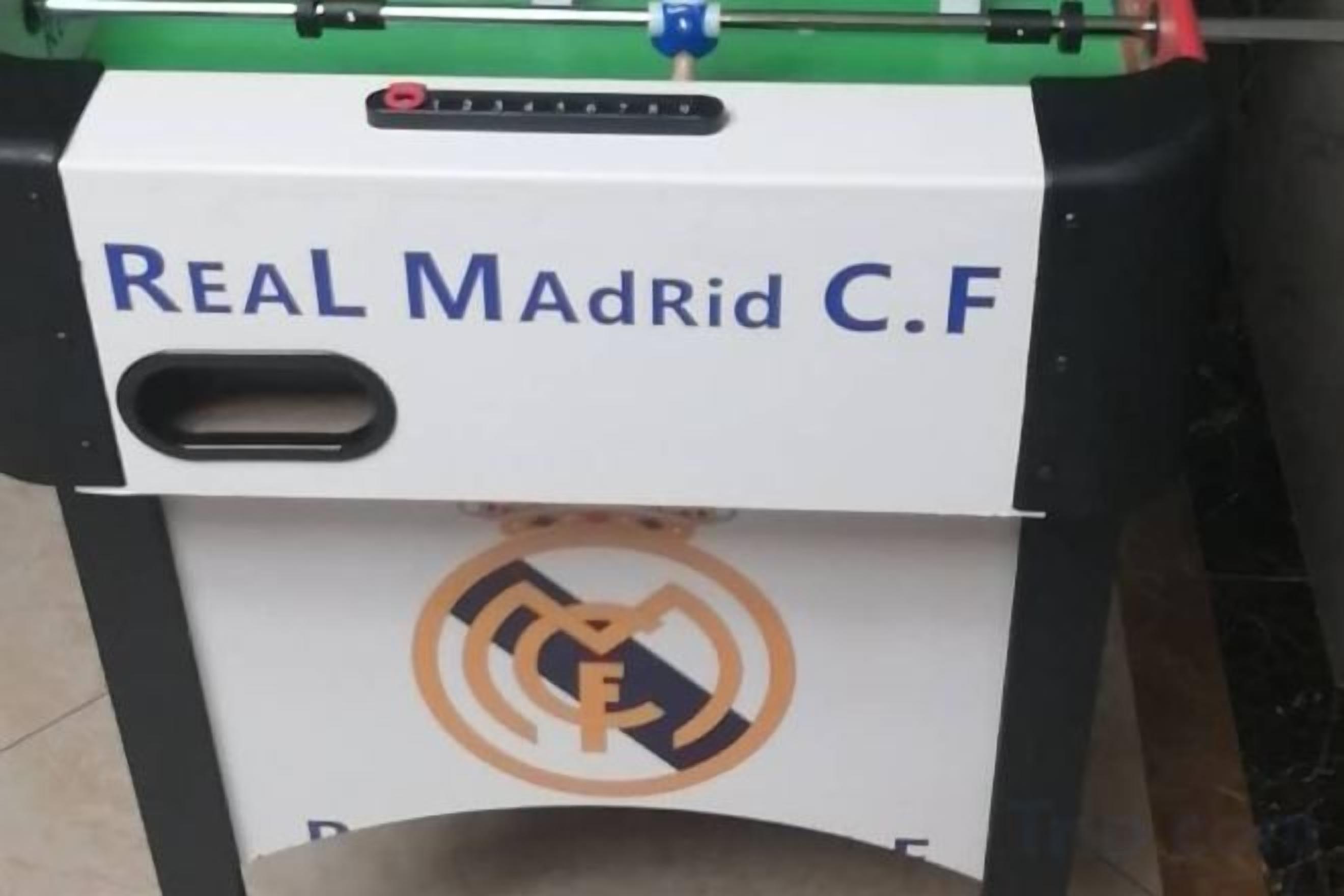 A piece of industrial equipment labeled 'REAL MadRid C.F' with a logo and a handle on the side.