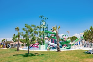 A water park with slides and pools, surrounded by palm trees and lounge chairs. - La Benata Hotel Luxury Concept - All Inclusive (Manavgat)