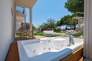 A modern outdoor bathroom with a large bathtub, wooden deck, and outdoor seating area. - La Benata Hotel Luxury Concept - All Inclusive (Manavgat)