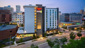 A Hampton Inn hotel with a modern design, featuring a prominent 'HOME 2' sign, multiple floors, and a well-lit facade. - Home2 Suites by Hilton Towson (Towson)