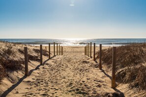 A sandy beach path leading to the ocean with wooden posts on either side. - NEW LISTING! Ocean block! Includes Linens! Beach and Bay Views! (Ocean City)