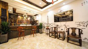 A modern interior with a bar area, seating, and decorative elements.