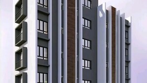 A modern multi-story building with a flat roof, large windows, and balconies. - SmileVew Apartments (Accra)