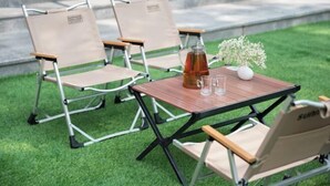 A table set outdoors with two chairs, a pitcher, glasses, and a vase with flowers. - Xingye International Hotel (Yiwu International Trade City) (Yiwu)