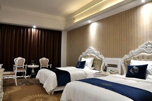 A hotel room with two beds, a small table with chairs, and a large window with curtains. - Tianyi International Hotel (Jianghua)