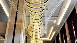 A modern interior with a unique spiral chandelier design.