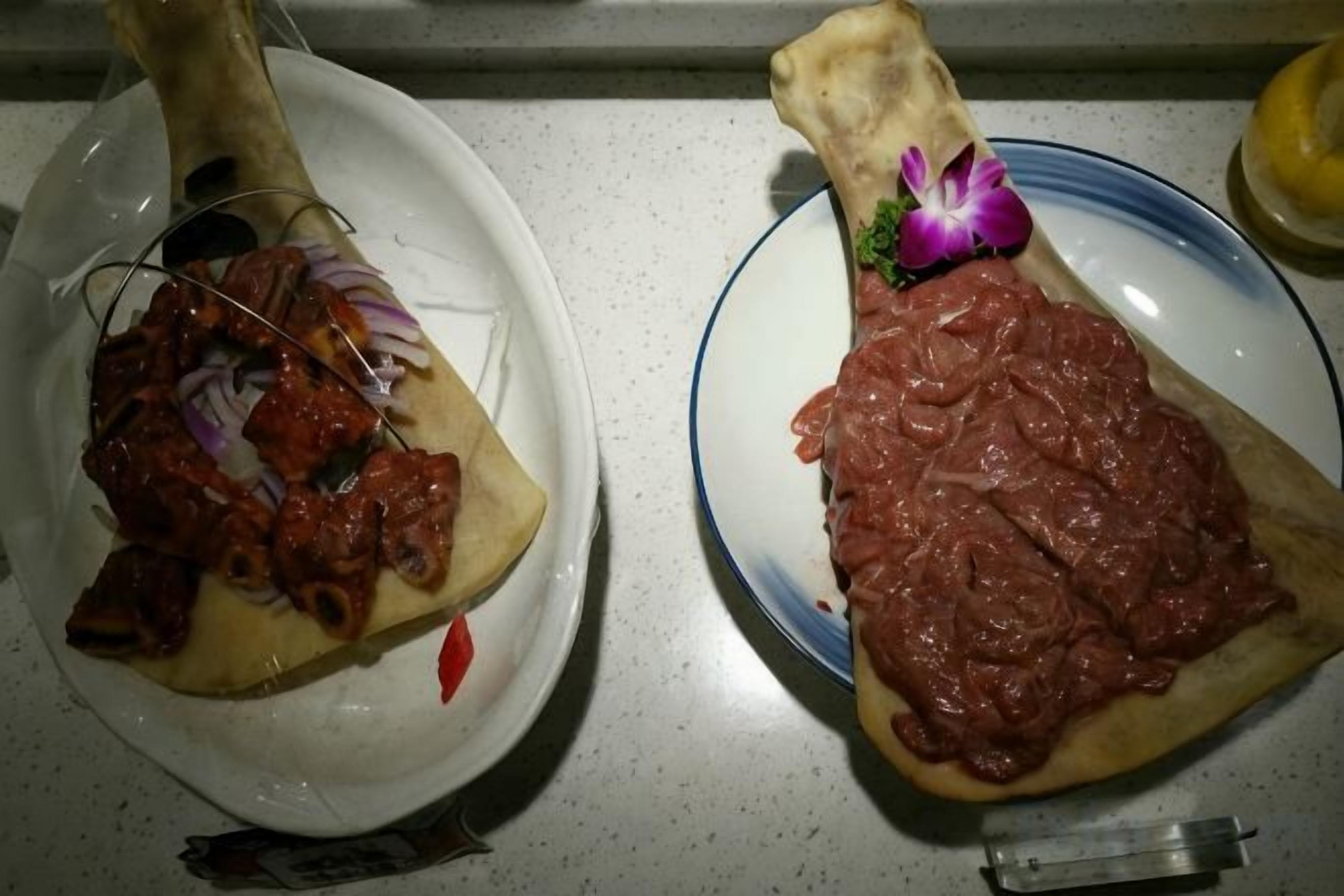 Two plates with food items on a countertop.