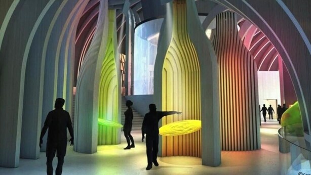 A modern architectural interior with curved columns and a central open space.