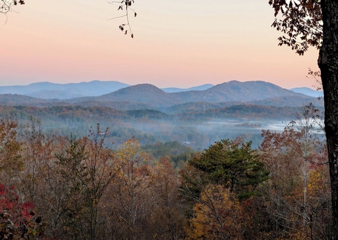A mountainous landscape with autumn foliage.