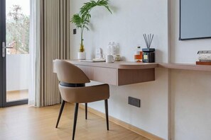 A modern room with a desk, chair, potted plant, and a view of the outdoors. - Anji Shanya Minsu Guesthouse (Anji)