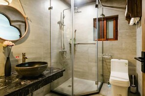 A bathroom with a glass-enclosed shower, a vessel sink, a toilet, and a mirror with a heart-shaped frame. - Wenjunge Jingju (Wuyuan)