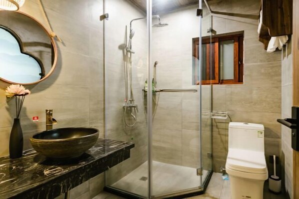 A bathroom with a glass-enclosed shower, a vessel sink, a toilet, and a mirror with a heart-shaped frame. - Wenjunge Jingju (Wuyuan)