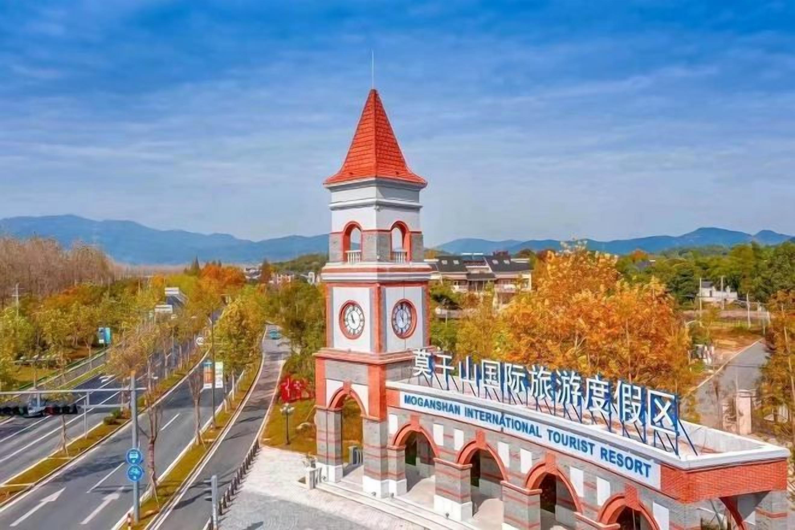 A red and white building with a clock tower, labeled as a tourist resort.