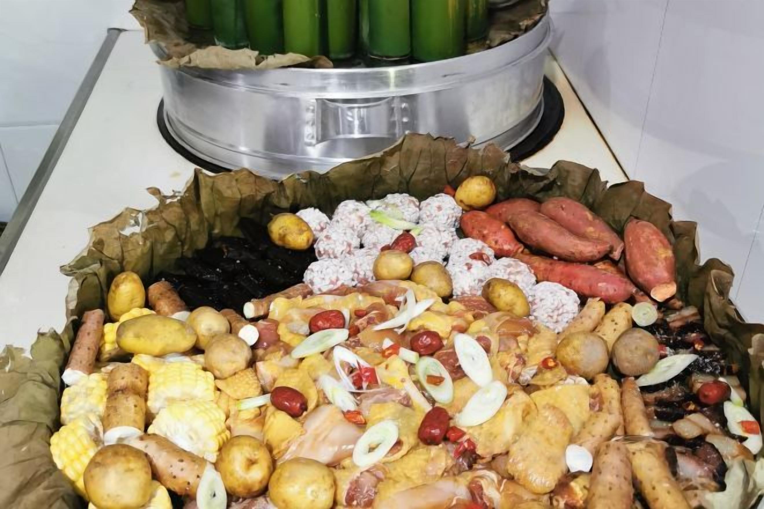 A large assortment of food items including sausages, potatoes, and corn on the cob.