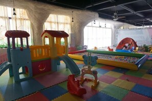 A play area with a slide, a ball pit, and a climbing structure.