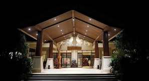 A hotel entrance with a wooden facade, large columns, and a sign above the doors. - Luminggu Hotel (Luzhai)