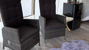 A tent with two black cushioned chairs and a coffee maker. - Heritage Ranch 'Big Sky' Glamping Tent (11) (Bozeman)
