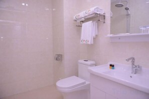 A bathroom with a toilet, sink, and shower. - Shuangsheng Saifu Business Hotel (Harbin)