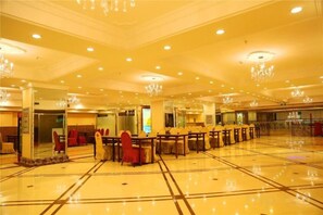 A spacious hotel lobby with a polished floor, multiple seating areas, and a chandelier. - Shuangsheng Saifu Business Hotel (Harbin)