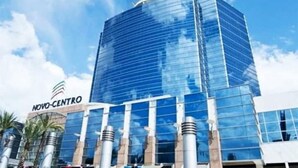 A modern glass building with the text "NOVO-CENTRO" on the facade.