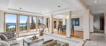 Stunningly situated home with expansive deck & mountain/water views