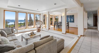 Stunningly situated home with expansive deck & mountain/water views