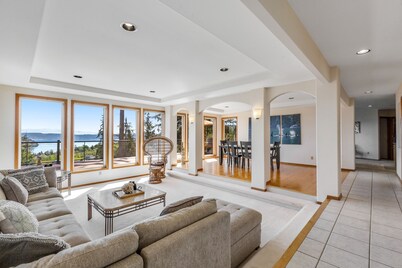 Stunningly situated home with expansive deck & mountain/water views