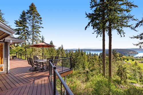 Stunningly situated home with expansive deck & mountain/water views