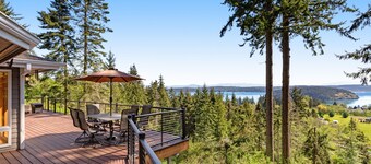 Stunningly situated home with expansive deck & mountain/water views