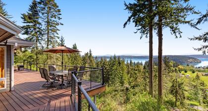 Stunningly situated home with expansive deck & mountain/water views