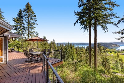 Stunningly situated home with expansive deck & mountain/water views