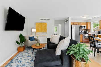 Spacious living area with plush sectional & smart TV