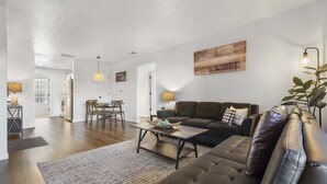 Ein modernes Wohnzimmer mit einer Couch, einem Couchtisch und einem Essbereich.