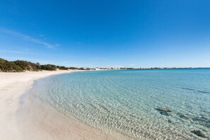 A clear beach with a sandy shore and calm water. - 3169 Villa Enea by Barbarhouse (Porto Cesareo)