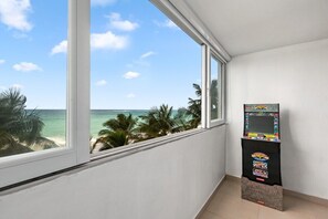 Enjoy ocean views from the large window, relax with a game on the arcade machine, and unwind in this stylish room.