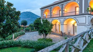 A large, multi-story building with a symmetrical facade, multiple arches, and a central courtyard. - Villa Artemisia in Piano di Sorrento (Piano di Sorrento)