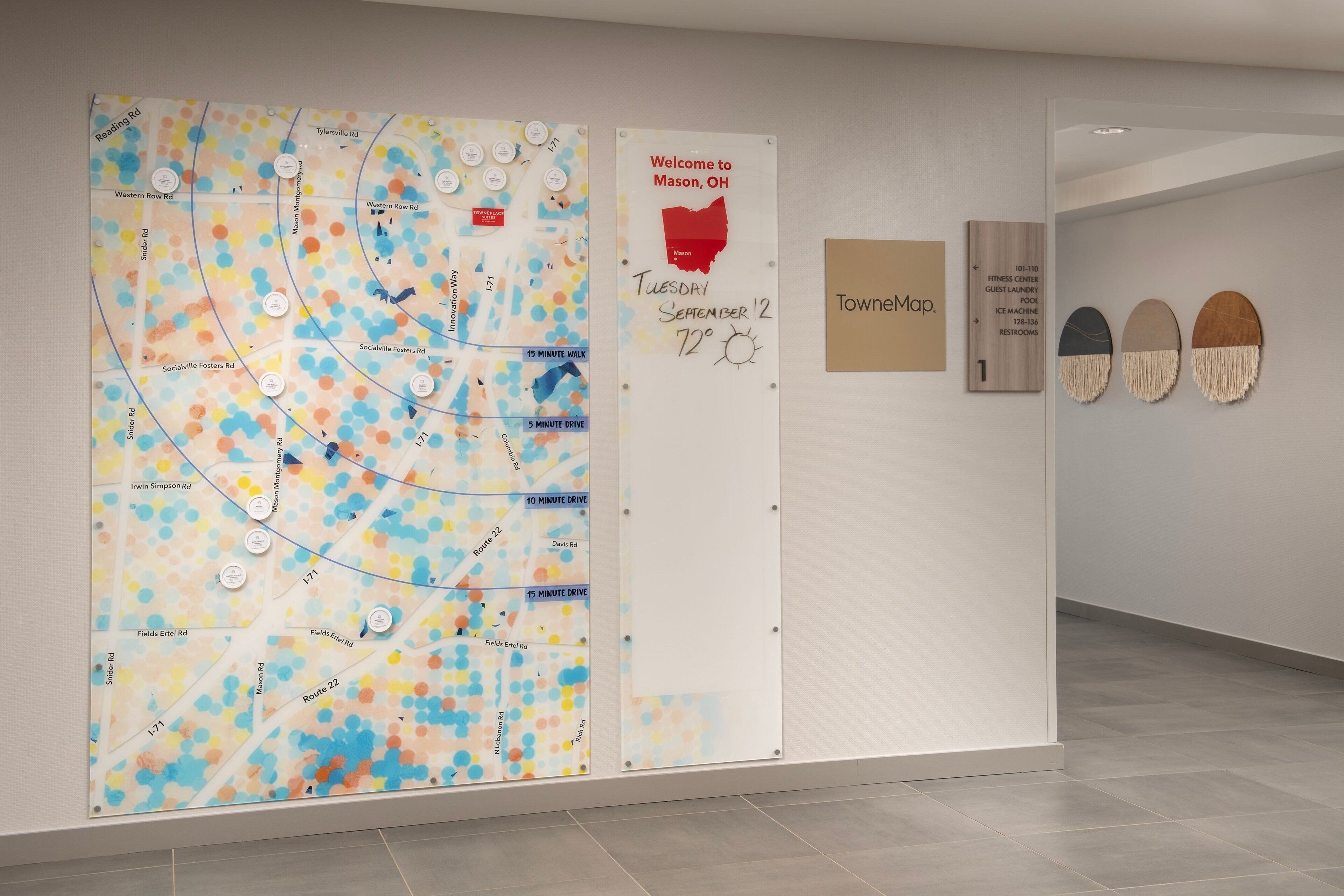 A map with various routes and amenities, a welcome sign, and a TowneMap sign.