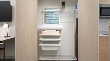 A modern, organized closet with shelves, a hanging rack, and a flat shelf.