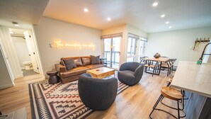 A modern living room with a leather sofa, a coffee table, and a patterned rug. - Wild Irishman 1054 (Keystone)