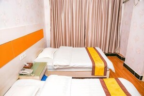 A hotel room with two beds, a nightstand, and a curtain. - Jujin Hotel (Jiangmen)