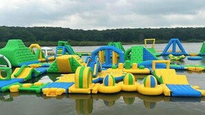 An inflatable water play area with various structures like slides and climbing walls. - Willow Springs Marina (Mead)