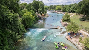 A river with clear water, surrounded by lush greenery and trees. - Ot 3515e Texas Yurt Haus: 5 Yurts! 5 Bedroom Cabin by RedAwning (New Braunfels)