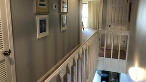 A staircase with white railings leading to a second floor. - 2 D, Three Bedroom Townhome (Miramar Beach)