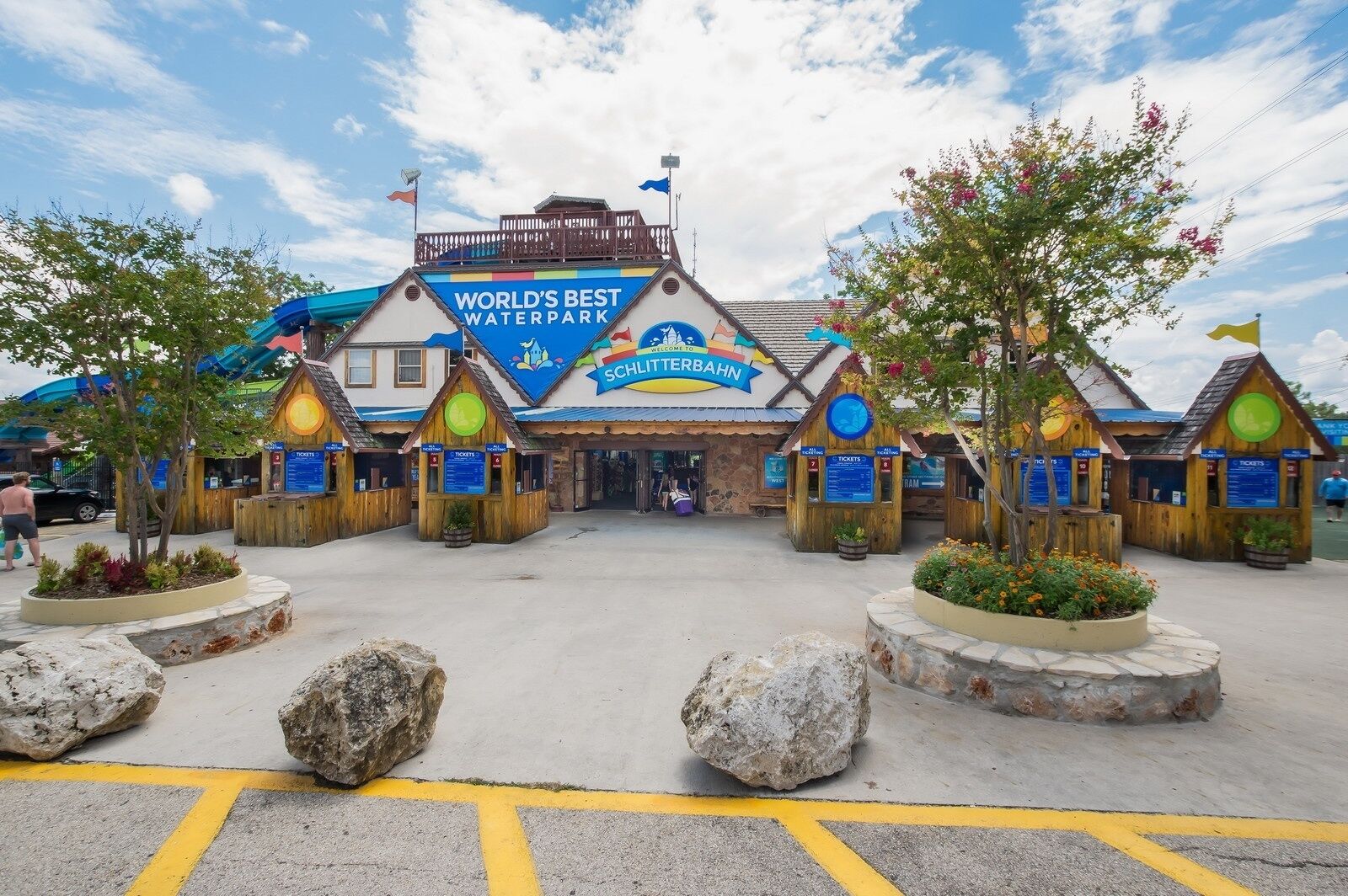 A wooden building with a sign that reads "WORLD'S BEST WATERPARK" and "WELCOME TO SCHLITTERBAHN".