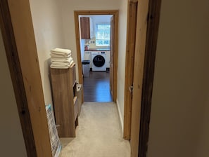 Laundry area with washer and dryer, convenient access to fresh towels.