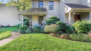 A two-story house with a front porch, a mailbox, and a well-maintained lawn. - Amazing Bayview: Swimming Pool, Harbor Views, Downtown Saugatuck, Balcony (Saugatuck)